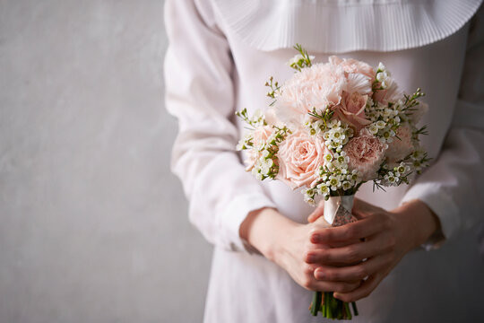 A woman holding a wedding bouquet