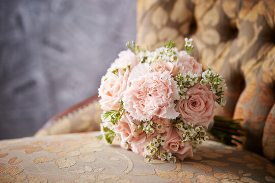 A bouquet of flowers on a vintage chair