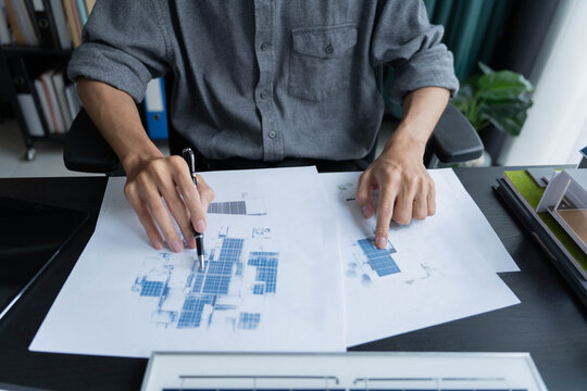 Electrical engineer working on solar panel blueprint sustainable energy