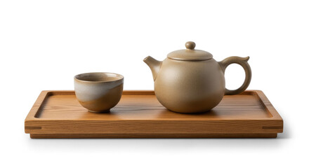 Fototapeta premium A ceramic tea set rests on a wooden tray. The tea set includes a teapot and a small cup.