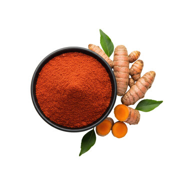 Matte black ceramic bowl filled with vibrant red paprika powder beside sliced golden turmeric roots and green curry leaves on white surface, culinary inspiration
