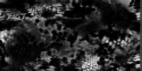 Abstract high-contrast black and white halftone dot pattern background with a grungy camouflage or distressed ink texture. © Axel