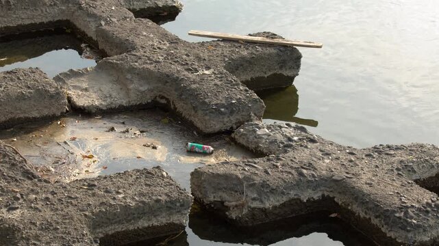 Aluminum Can Floating Near Concrete River Barriers in Kyoto Japan