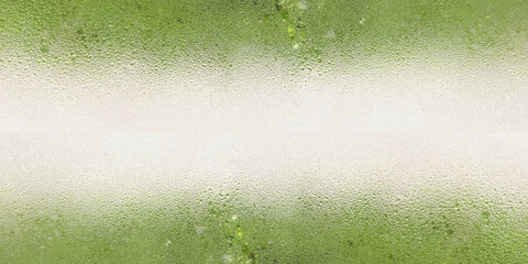 Fototapeta premium Grainy noise frosted glass texture with condensed water rain drops over blurred natural green backdrop. Features a horizontal bright gradient center ideal for copy space