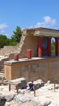 Tourists exploring the ancient Knossos Palace in Crete Greece