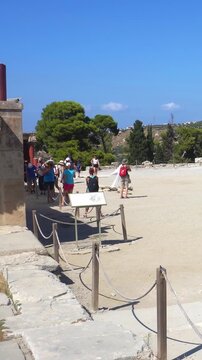 Tourists visiting ruins of Knossos palace in Greece