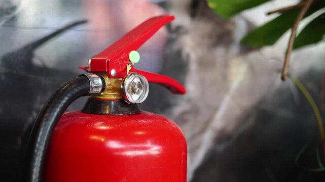 Using fire extinguisher to fight small fire indoors