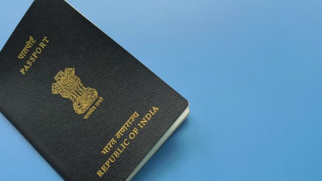 Passport of india official government indian citizenship identification document isolated on blue background with copy space. Traveller personal nationality identity proof for international travel.