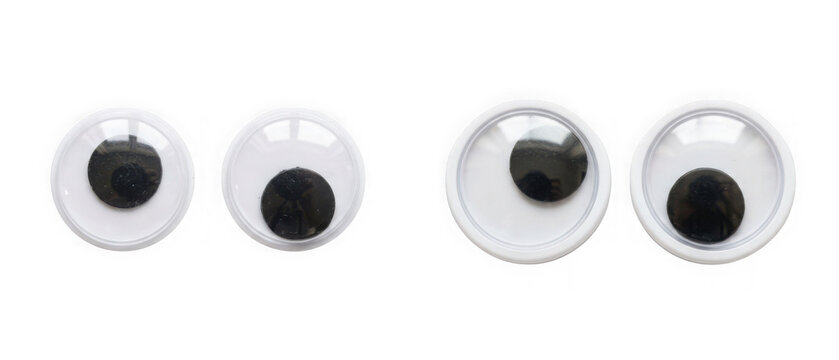 Four googly eyes of different sizes isolated on transparent background