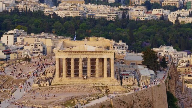 Aerial view of the parthenon temple on the acropolis hill in athens, a famous ancient greek landmark attracting many tourists exploring the historic ruins and the surrounding cityscape