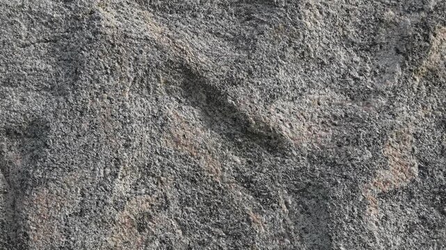 Close-up of natural granite rock surface with swirling patterns