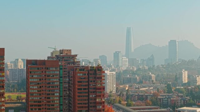 Aerial Tilt Up of Las Condes Neighborhood with Skyscrapers and Andes Mountains Background in Santiago de Chile