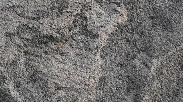 Close-up of natural granite rock surface with swirling patterns