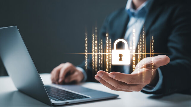 Businessman holding glowing digital padlock with binary code above laptop computer screen with displays businessman digitalization cybersecurity