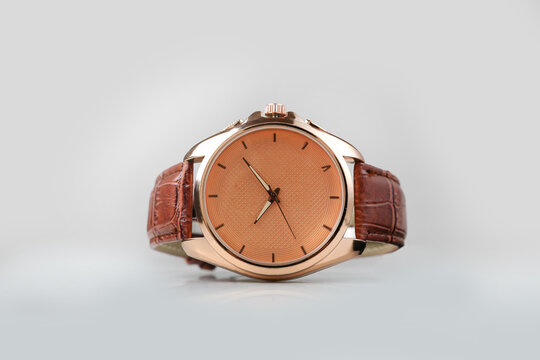 Luxury rose gold men wrist watch with brown leather strap isolated on white background.