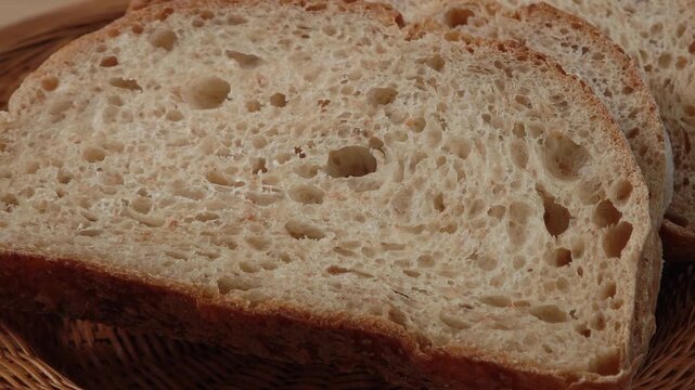 Close-up of sliced ​​piece of whole grain bread. Bread crumb texture, artisan sourdough organic bread macro photography.