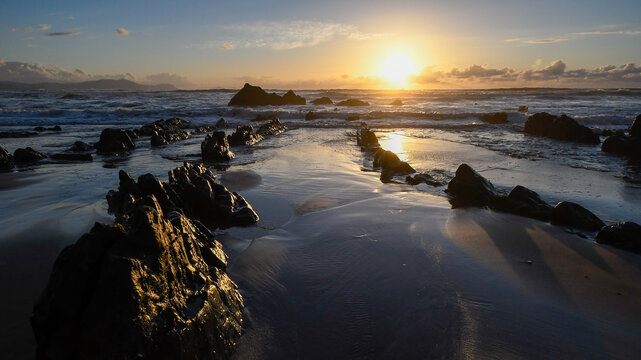 Smooth Silk Water and Dramatic Sunset Sky over Barrika Coastal Flysch Rock Formations