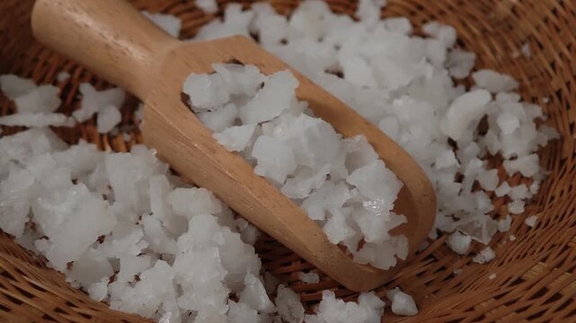 Close-up of Coarse Sea Salt Crystals on a Wooden Spoon.