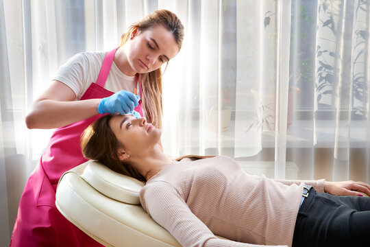 Professional eyebrow correction in a beauty salon