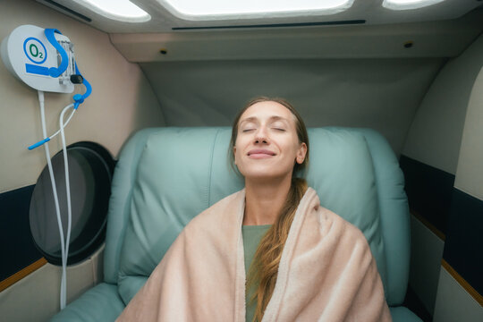 Woman Undergoing Hyperbaric Oxygen Therapy in Modern Wellness Clinic
