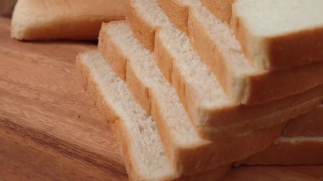French bread slices on wooden cutting surface