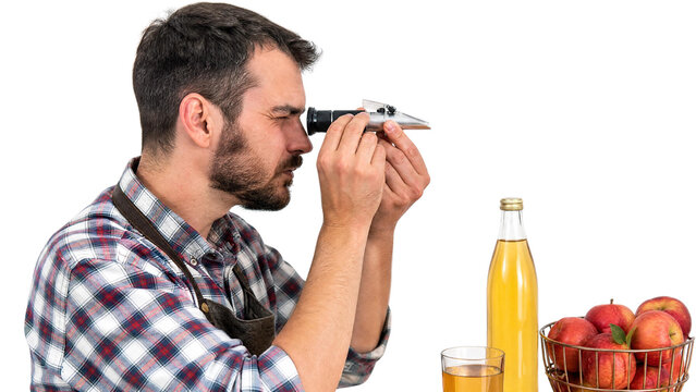 Man Cider Maker Testing Sugar Content of Apple Juice with Refractometer Isolated