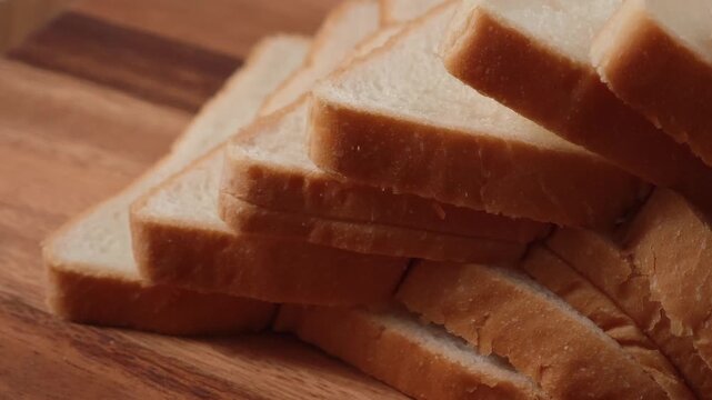 French bread slices on wooden cutting surface