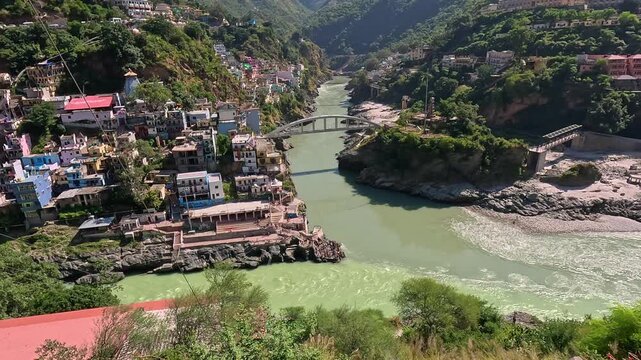 High-angle view of Devprayag Sangam, the sacred confluence of Alaknanda and Bhagirathi rivers forming the Ganga, India.