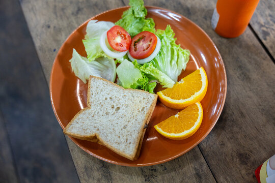 Sandwich lettuce tomato onion orange breakfast healthy fresh wooden plate meal lunch vegetable slice bread citrus snack vegetarian diet rustic homemade nutrition organic food salad appetizer