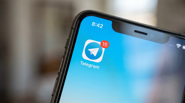 In this photo illustration, the Telegram app logo is seen displayed on a smartphone screen with a red notification badge, representing social media messaging, digital communication and technology.