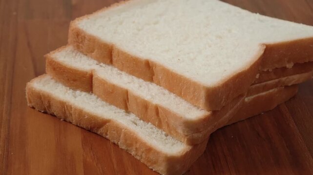 French bread slices on wooden cutting surface