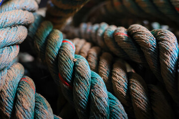 Close up textured thick twisted blue brown rope fiber detail rugged strong durable nautical industrial outdoor weathered rough heavy cord equipment maritime strength pattern coil surface macro © CoreRock