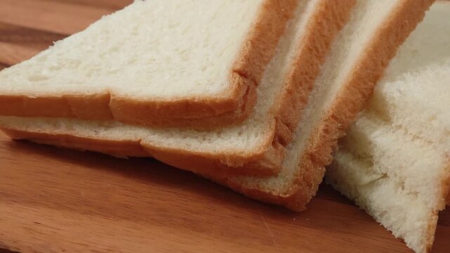 French bread slices on wooden cutting surface