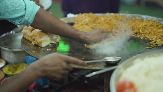 Pav Bhaji Cooking on Street Tawa, Indian Street Style Pav Bhaji, Hot Pav Bhaji Preparation, Street Food Vendor Making Pav Bhaji stock video.