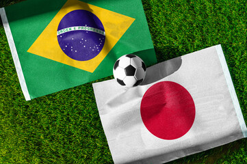 Fototapeta premium Brazil vs Japan, national flags before international football tournament Round of 32 match, football on green grass with goal in the background, Houston, Texas, USA, June 29, 2026