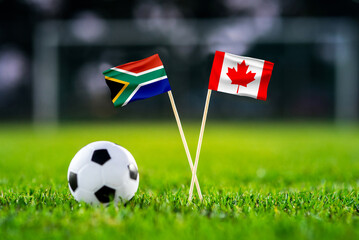 Naklejka premium South Africa vs Canada, national flags before international football tournament Round of 32 match, football on green grass with goal in the background, Inglewood, California, USA, June 28, 2026