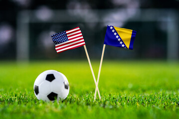 Obraz premium United States vs Bosnia and Herzegovina, national flags before international football tournament Round of 32 match, football on grass with ball, Santa Clara, California, USA, July 1, 2026