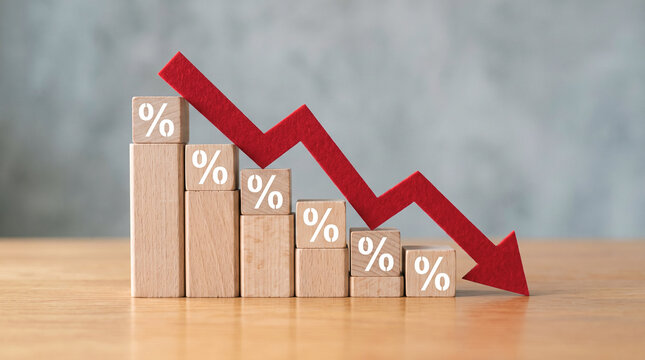 Wooden blocks forming a descending bar chart with percentage symbols and a red arrow indicating financial decline