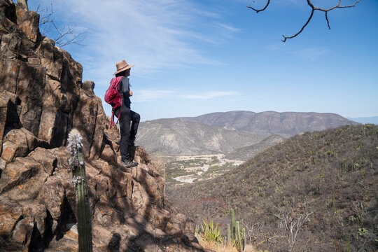 Female hiker looking out over a vast desert valley