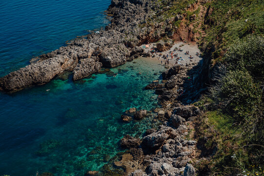 Pebble beach and crystal clear water at Cala Berretta, Sicily