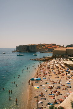 Banje Beach and Dubrovnik Old Town Walls on a Sunny Summer Day
