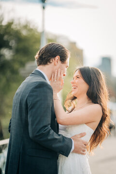 Engaged couple laughing together in warm light