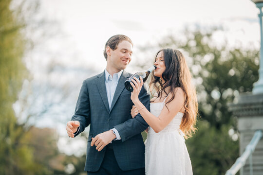Couple celebrating engagement drinking champagne outdoor