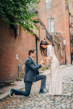 Man proposing marriage to woman on acorn street boston