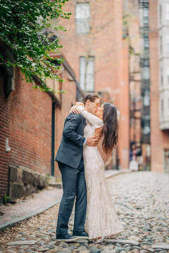 Wedding couple kissing on acorn street boston