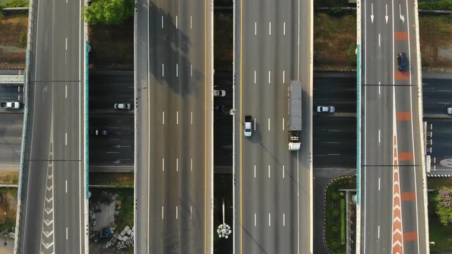 Daylight highway traffic showcases subdued movement of vehicles on multi-lane road during tranquil daylight hours, presenting an appealing scene for travel and automotive photography.