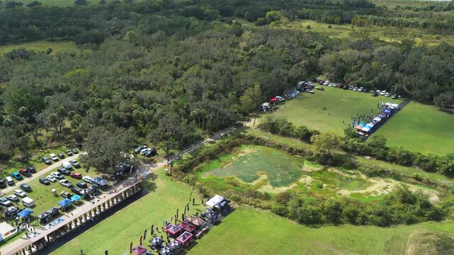 Shooting range complex with expo activity and testing lanes, aerial angled pullback