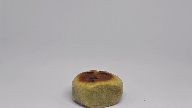 Hand stacking bakpia pastries one by one