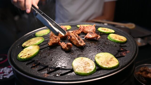 Grilling Chicken and Vegetables on a Korean BBQ Table with Steam