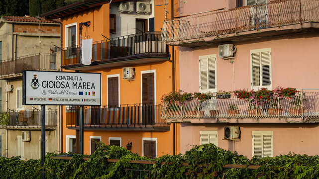 Gioiosa Marea, Sicily, July 23, 2025  gioiosa marea station sign with residential buildings in sicily